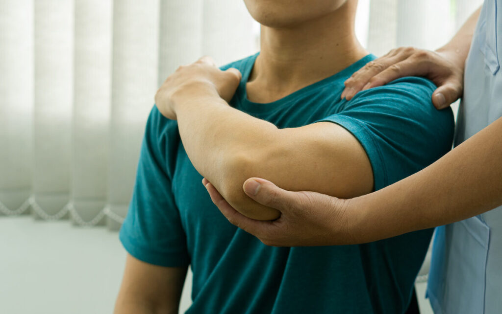 Young man with chronic arm pain